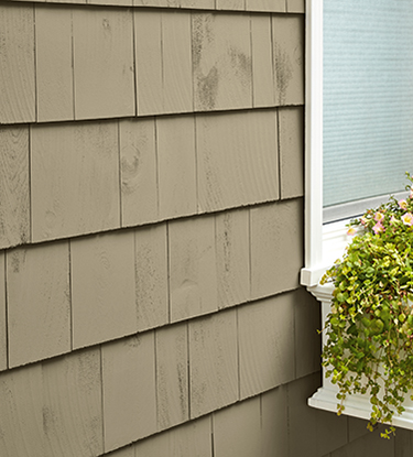 cedar siding with small flower bed